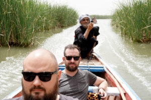 people on boat in marshes in Iraq