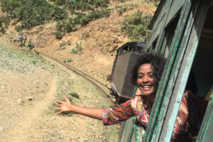 Women hanging out of a traditional steam train in Eritrea