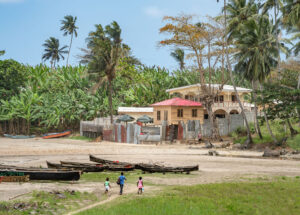 African Fishermen Village by the sea in Sao Tome and Principe near mountains like Pico Cao Grande. Travel to Sao Tome and Principe to see a beautiful paradise island in Gulf of Guinea in Africa