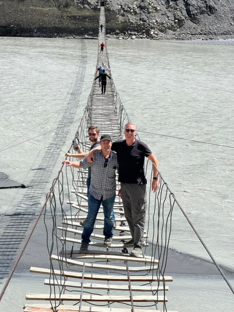 People on the Passu Suspension Bridge in Pakistan