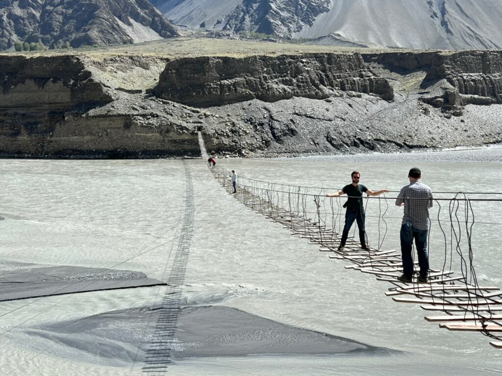 Visitors to Passu Suspension Bridge in Passu, Pakistan