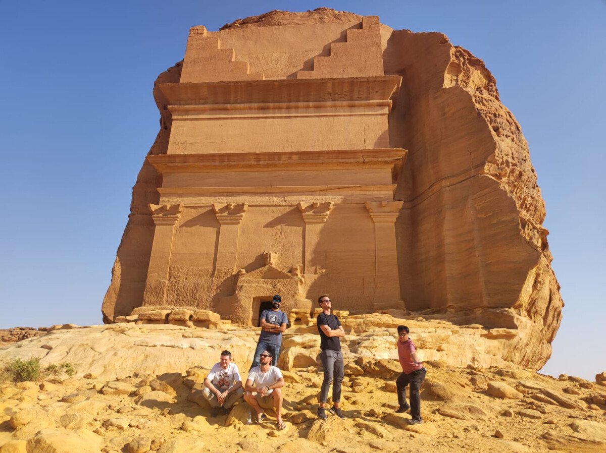 group photo in front of al-ula